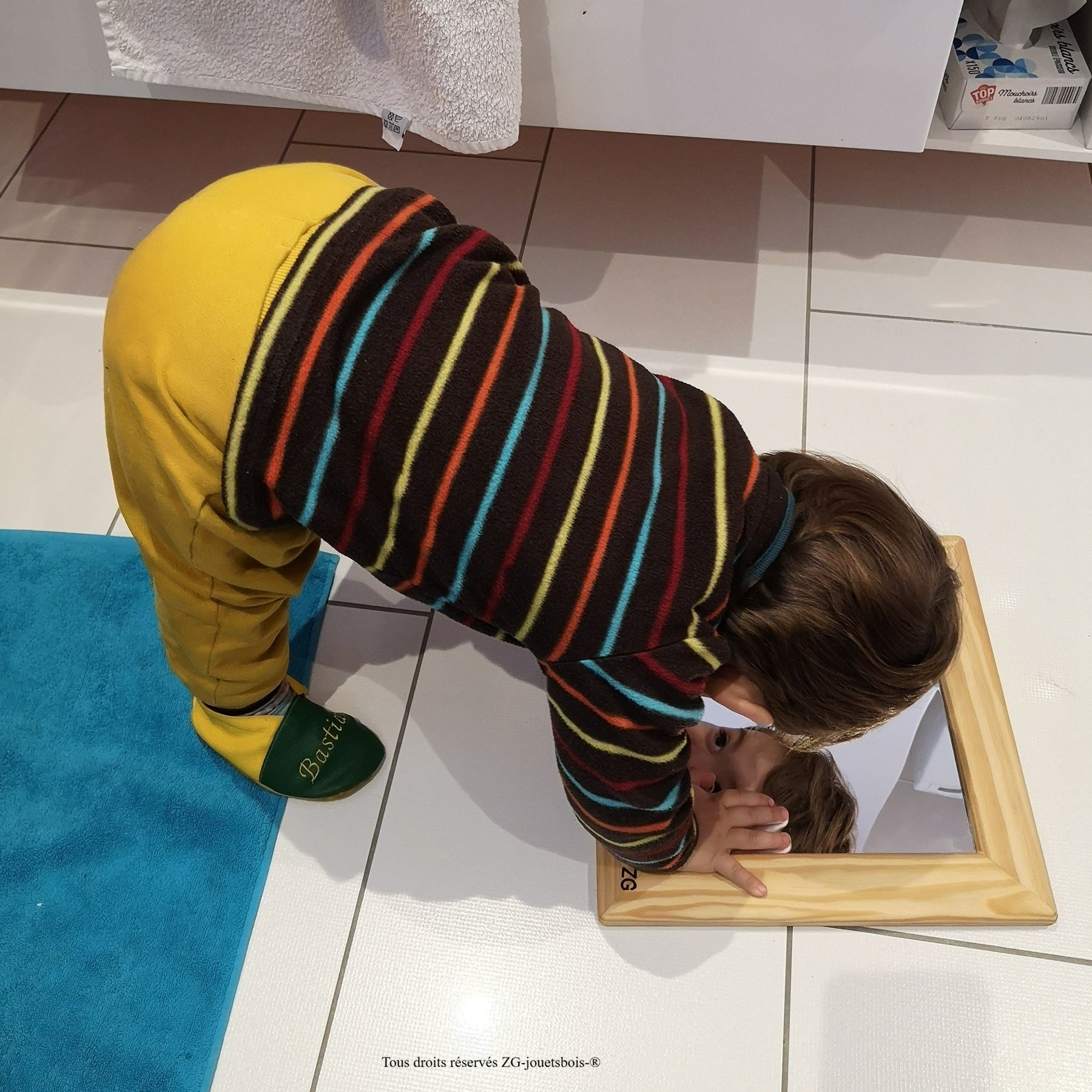 jeune enfant se regardant dans miroir incassable montessori